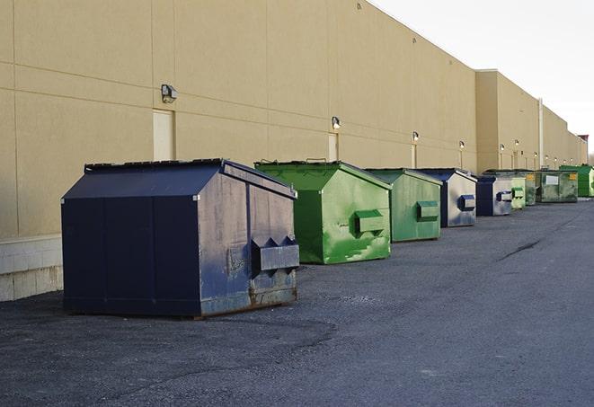 a construction worker moves construction materials near a dumpster in Browns Mills, NJ